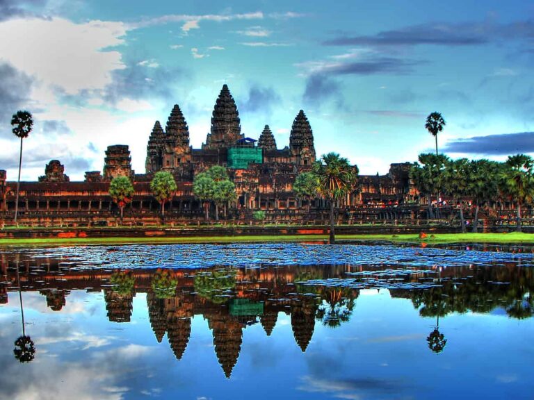 A breathtaking view of Angkor Wat at sunrise, highlighting its majestic towers and intricate carvings